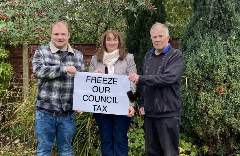 3 Candidates holding a sign