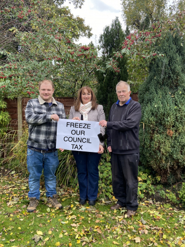 3 Candidates holding a sign